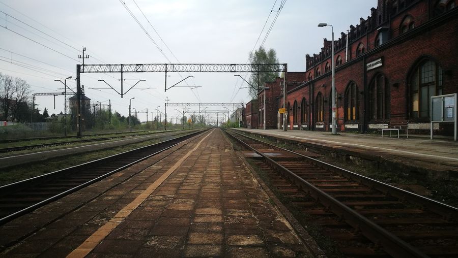 Empty railroad platform against sky