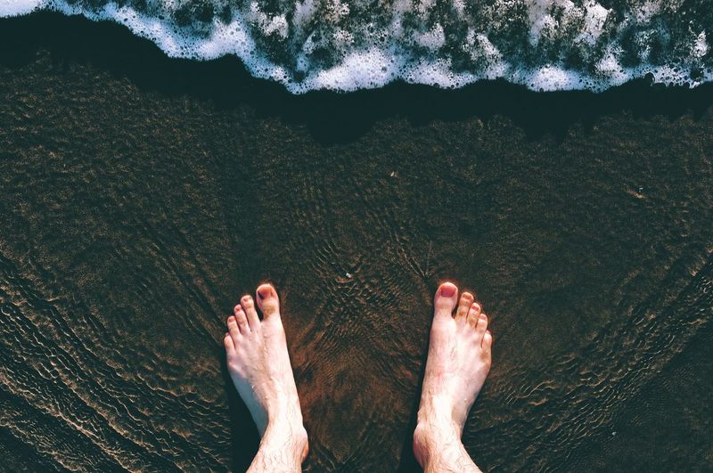 Low section of man in sea