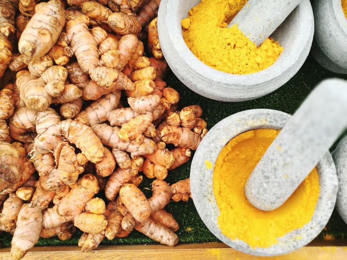 Directly above shot of ginger with turmeric in mortar