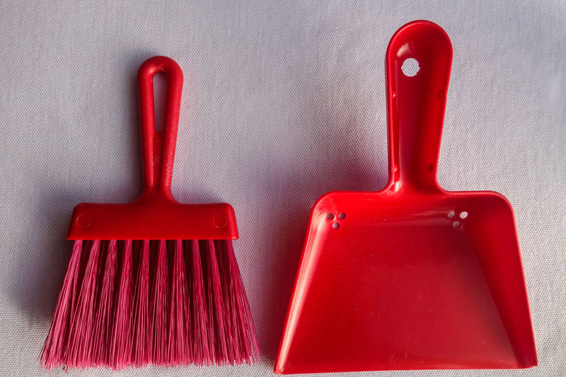 Directly above shot of small broom and dustpan on table
