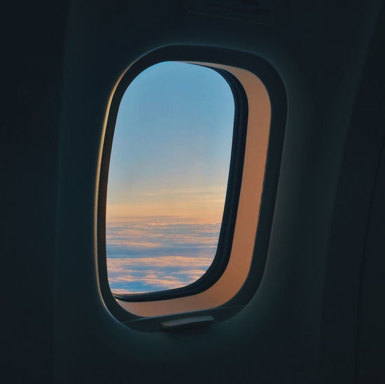 Cloudy sky seen through airplane window