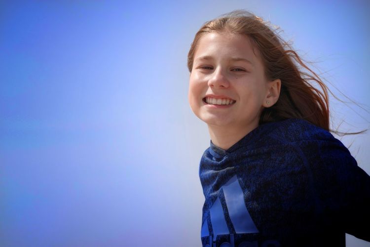 Portrait of cute girl against sky 