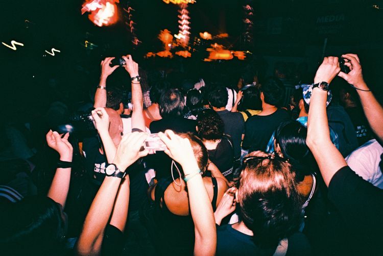 Crowd of people on a concert with some taking photos