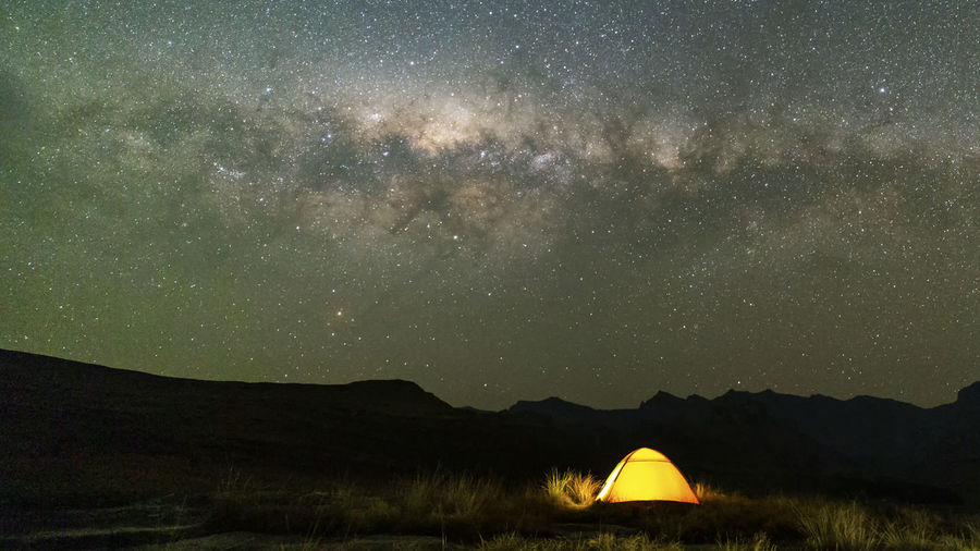 Scenic view of tent against sky at night
