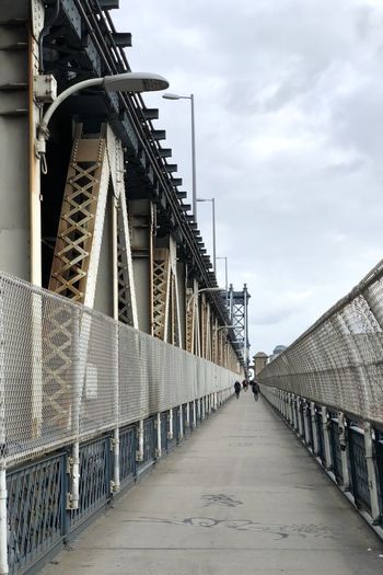 Footbridge over bridge against sky