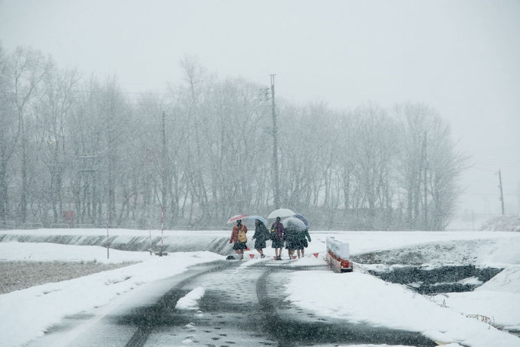 People walking on road in winter