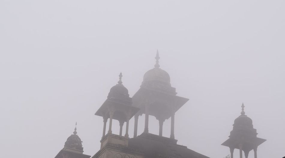 Mosque against sky during foggy weather