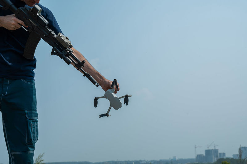 Caucasian man caught a drone shoots from a rifle. air espionage