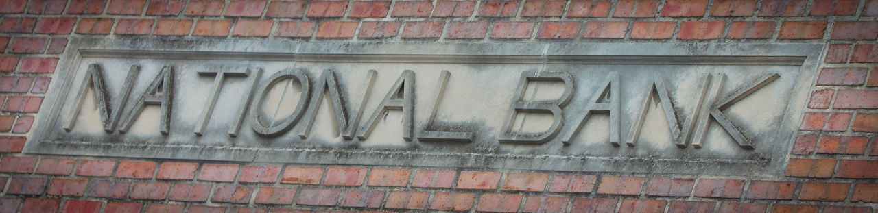 Close-up of text on brick wall