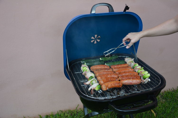 High angle view of person preparing food on barbecue
