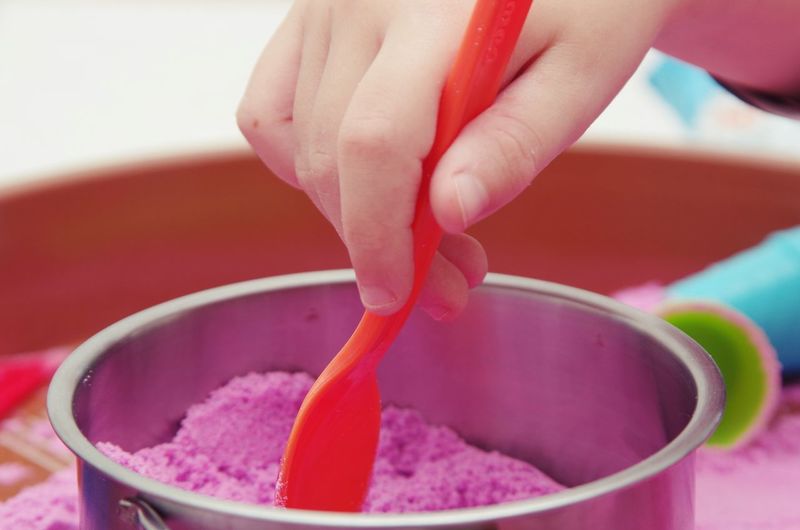 Close-up of hand holding ice cream in bowl