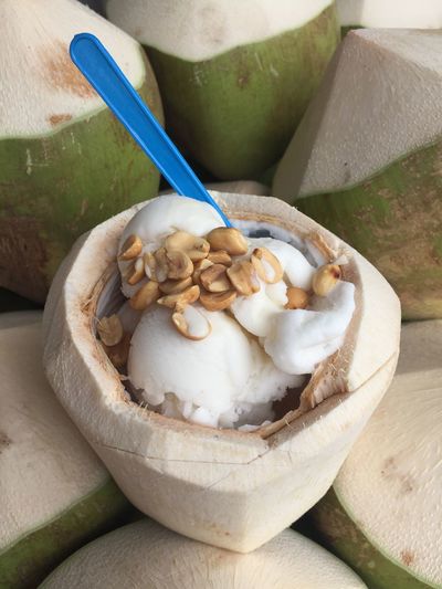 Close-up of ice cream and peanuts in coconut