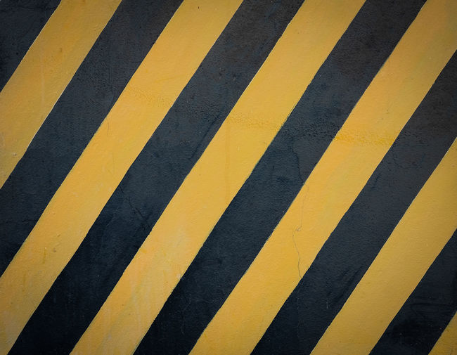 High angle view of yellow crossing sign on road