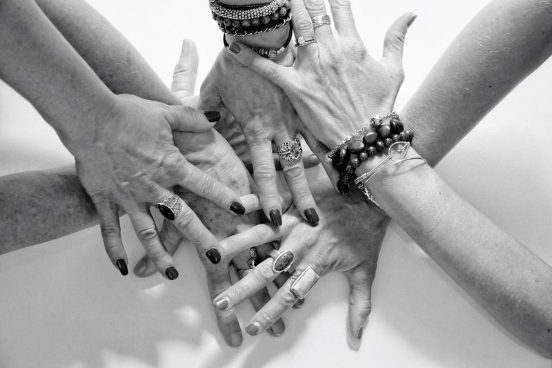 High angle view of friends stacking hands