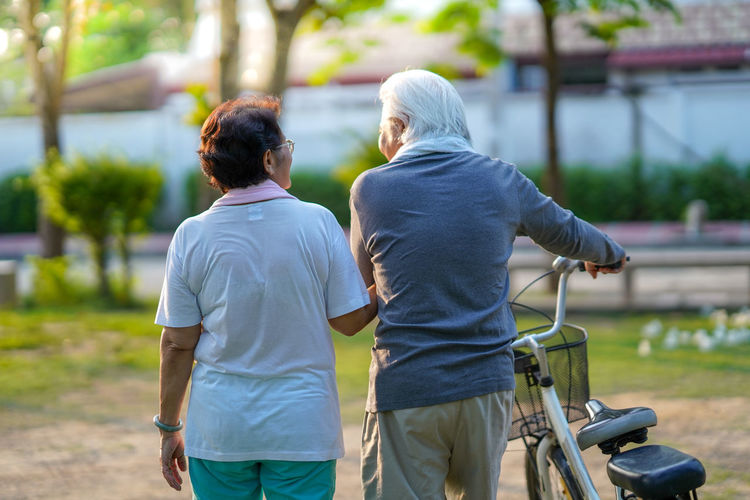 Rear view of people walking outdoors