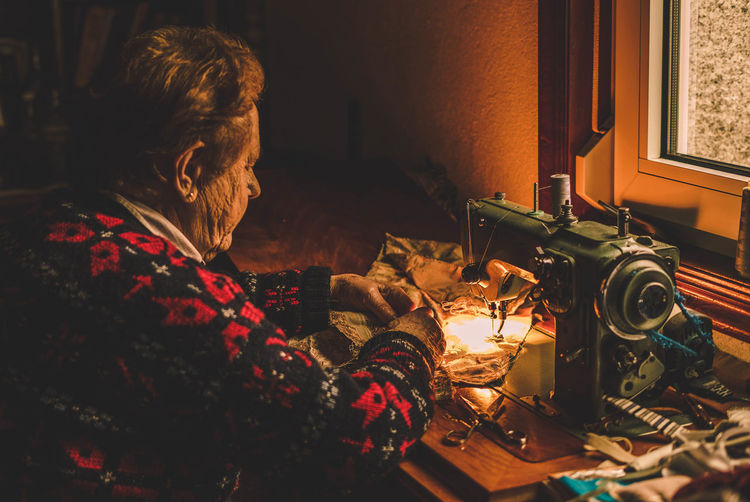 Woman sews to machine