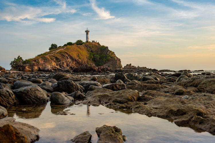 Light house at lanta krabi with water reflection and sky during sunset. 