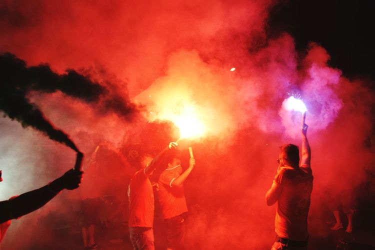 People holding flares