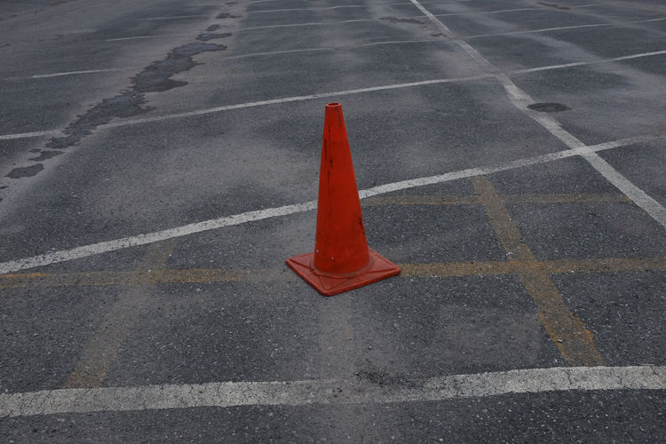 High angle view of red traffic cone at parking lot
