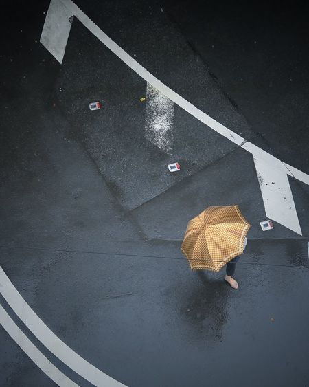 High angle view of umbrella on wet street
