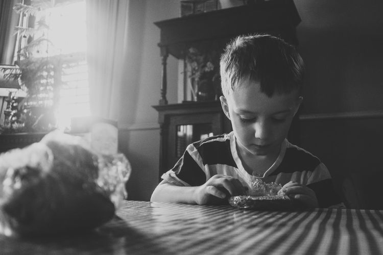 Portrait of boy looking at table at home
