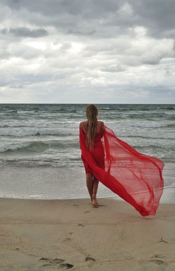 Woman on beach against sky