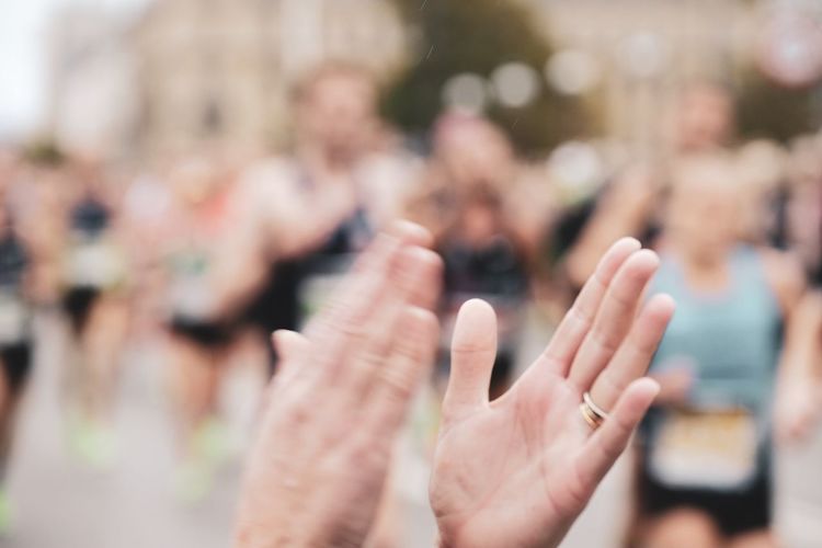 Cropped image of person clapping hands outdoors