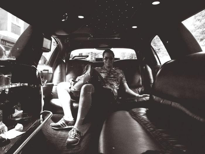 Young man sitting in limousine