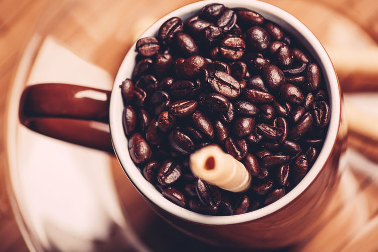 High angle view of coffee beans in bowl on table