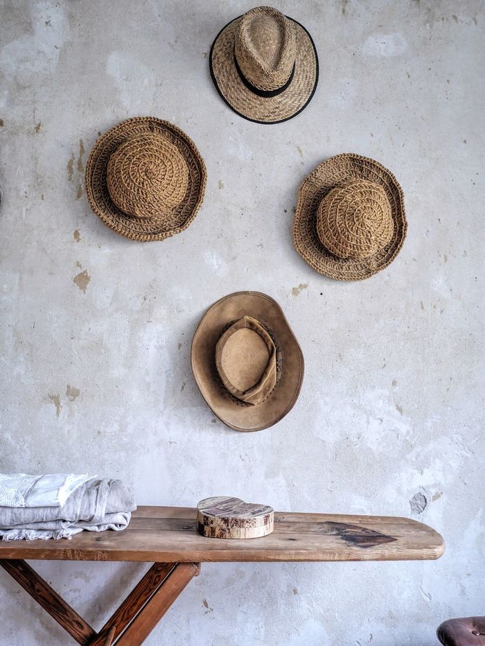Table against wall with hats at home