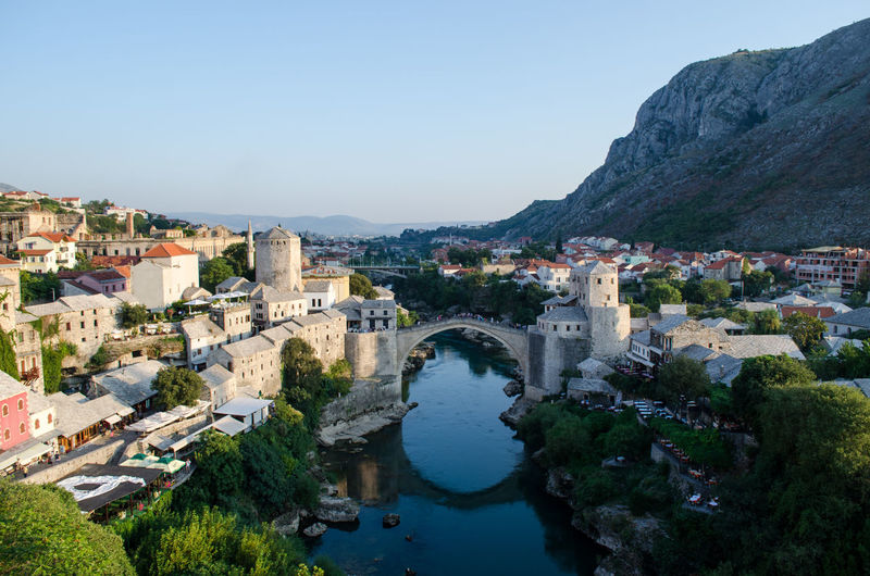 Stari most over river against sky in city
