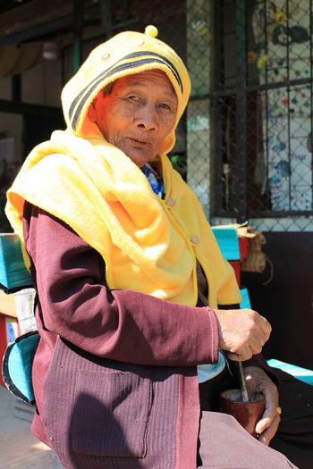 Senoir woman wearing a yellow winter cloth.