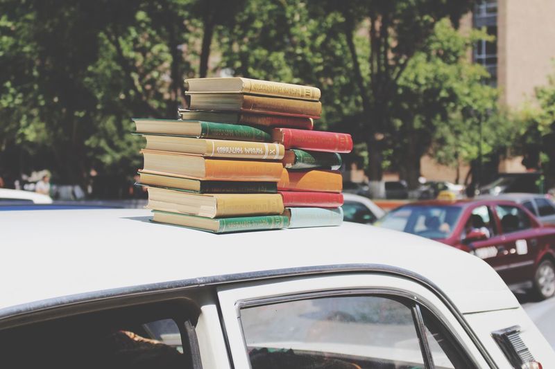 Stack of books on car.