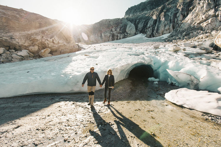Retired couple enjoying a day exploring a glacial ice cave.
