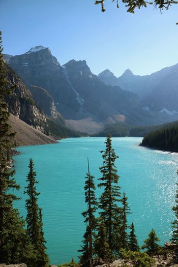 Scenic view of lake and mountains against blue sky