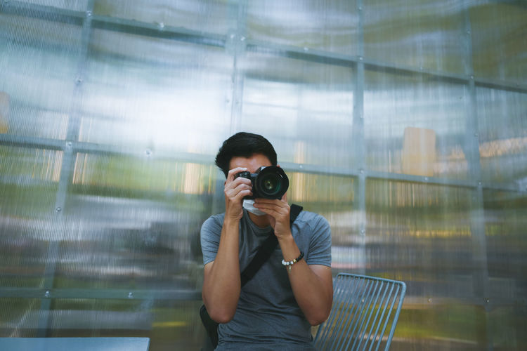 Young man using camera , inspiration ,travel and recreation concept