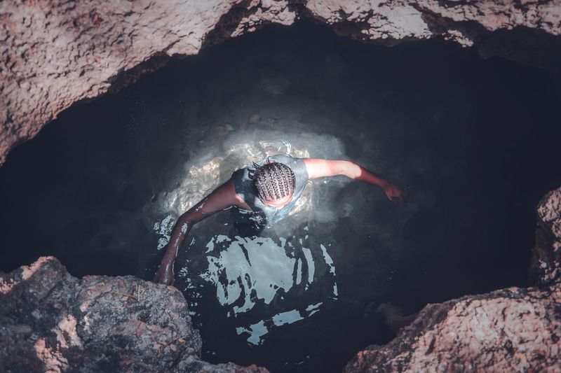 Man swimming in cave