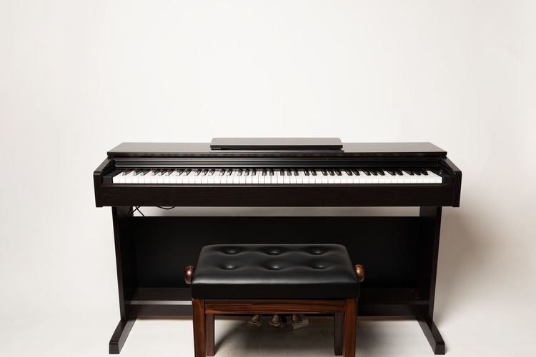 View of piano against white background