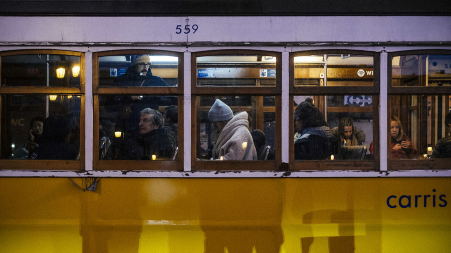 Reflection of people on glass window of train