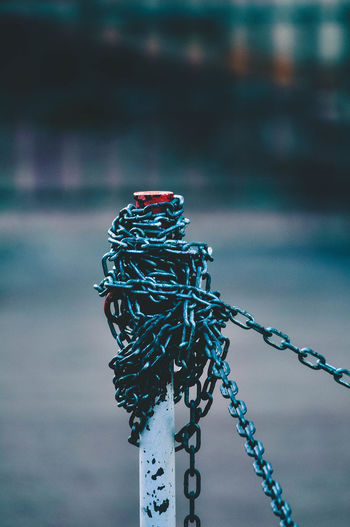 Close-up of chain tied on pole
