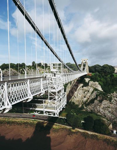 View of suspension bridge against cloudy sky