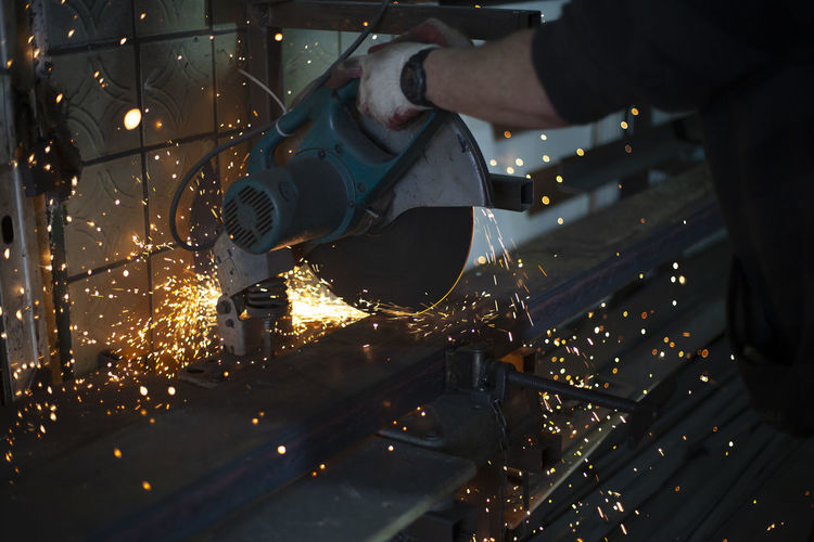 Sawing steel. circular saw and sparks. production details. metal cutting. details of work.