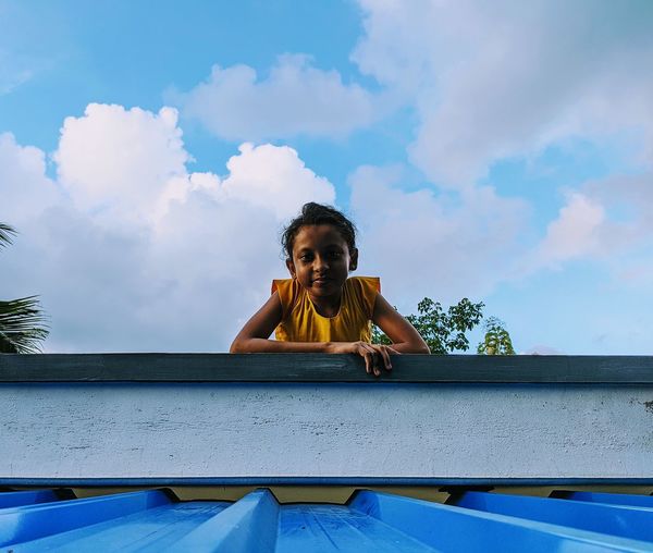 Portrait of girl against blue sky