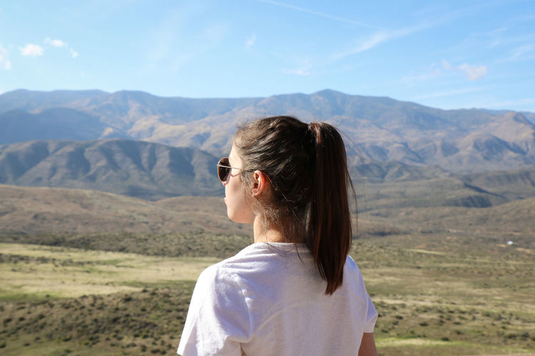 Rear view of woman looking at mountains