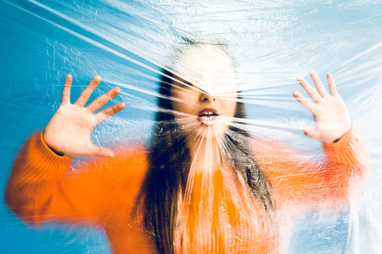 Portrait of teenage girl trapped in plastic