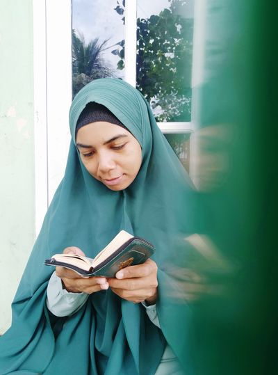 Young woman reading qur'an