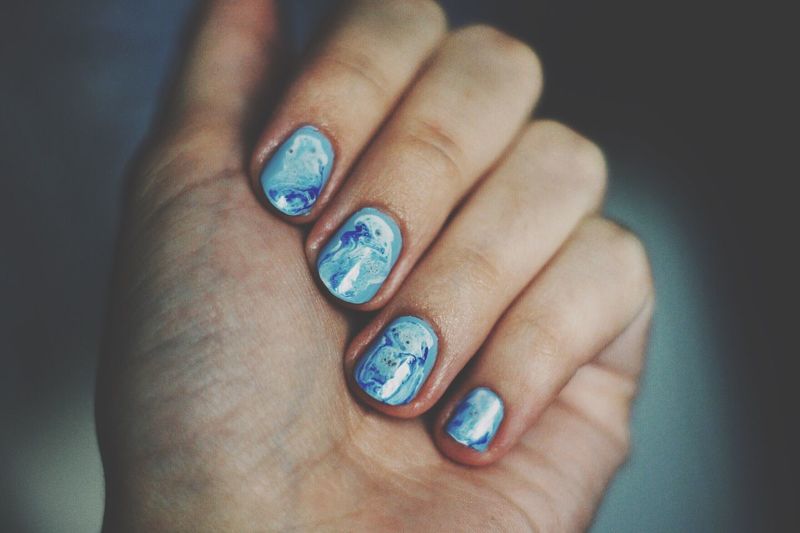 Cropped hand of woman with nail art