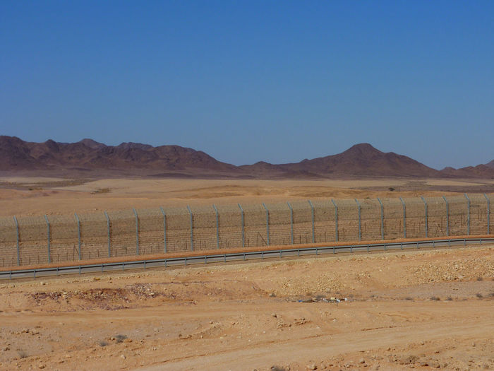 Border in desert against clear sky