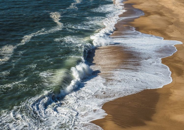 High angle view of waves on beach