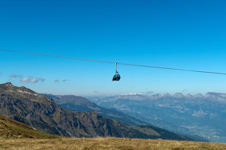 Overhead cable car against mountains